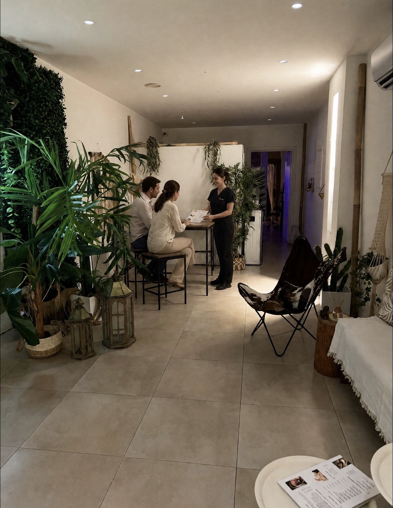 Massage professional explaining ritual choices to an adult couple inside The Moment