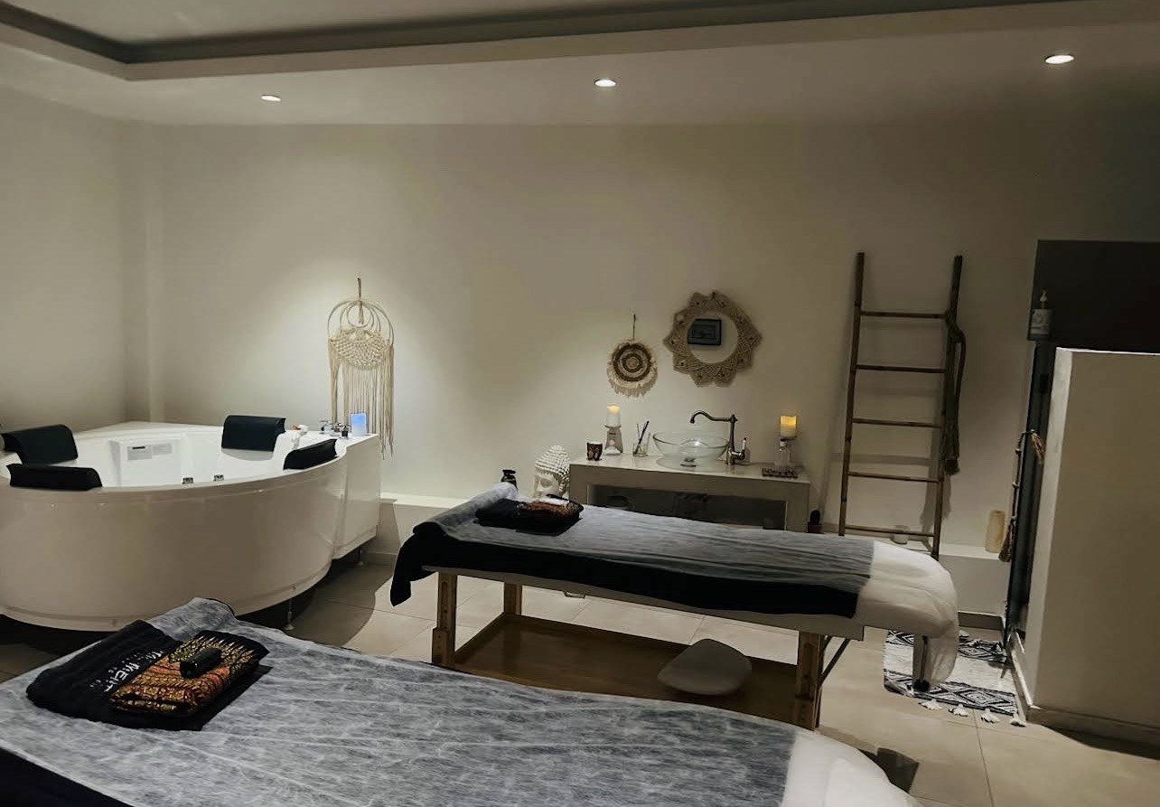 Private massage suite with two beds and a jacuzzi in Central Athens
